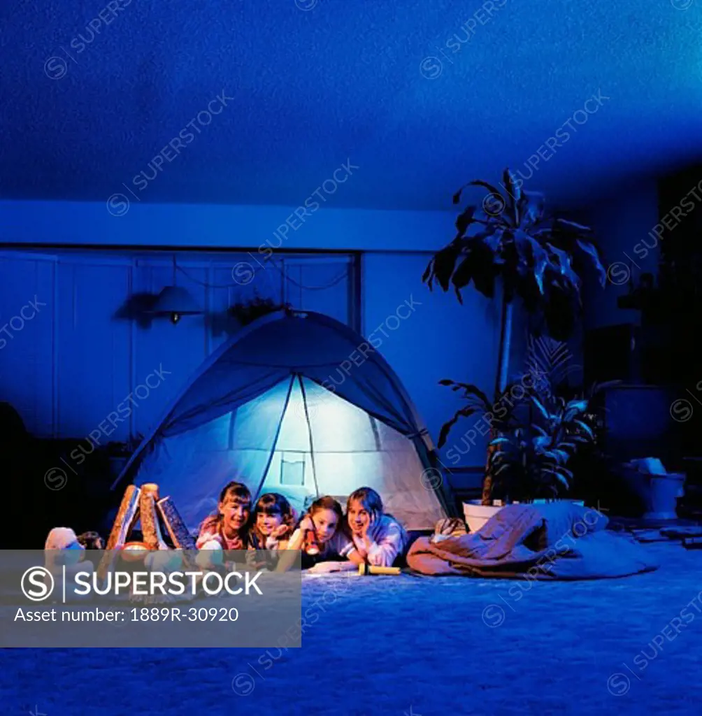 Girls sitting in a tent in the living room