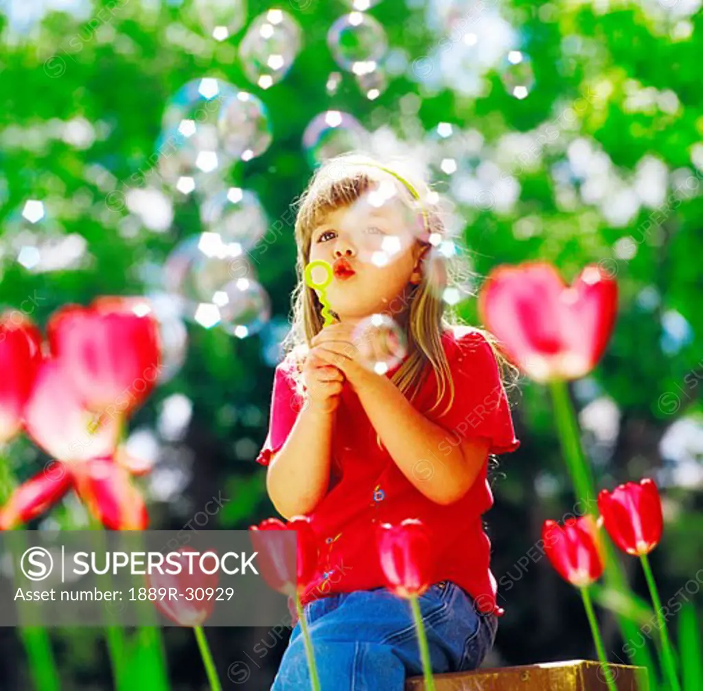 A girl blowing bubbles