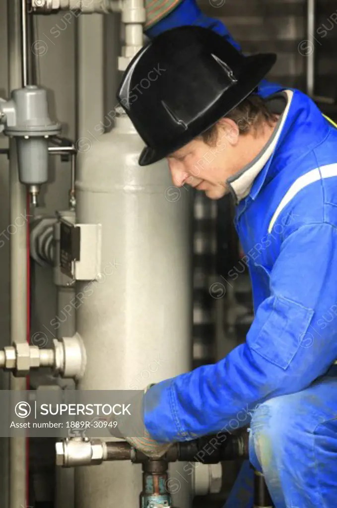 Industrial worker adjusting equipment