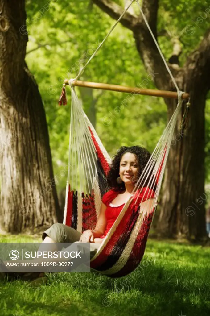 Young adult female sitting on hammock