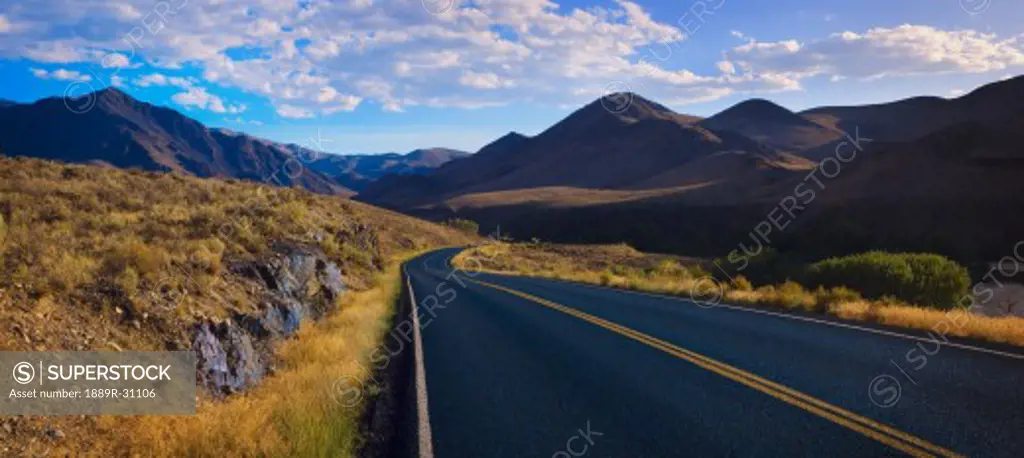 Panoramic view of foothills road with mountains  
