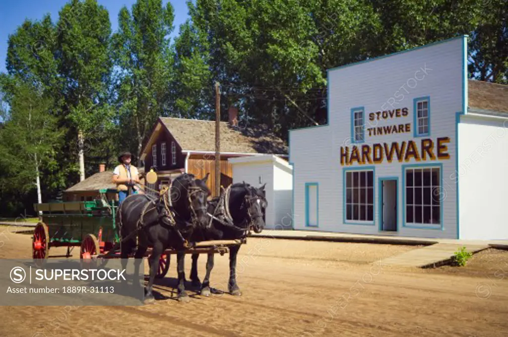 Fort Edmonton Park, horse team and wagon pass historic hardware store   