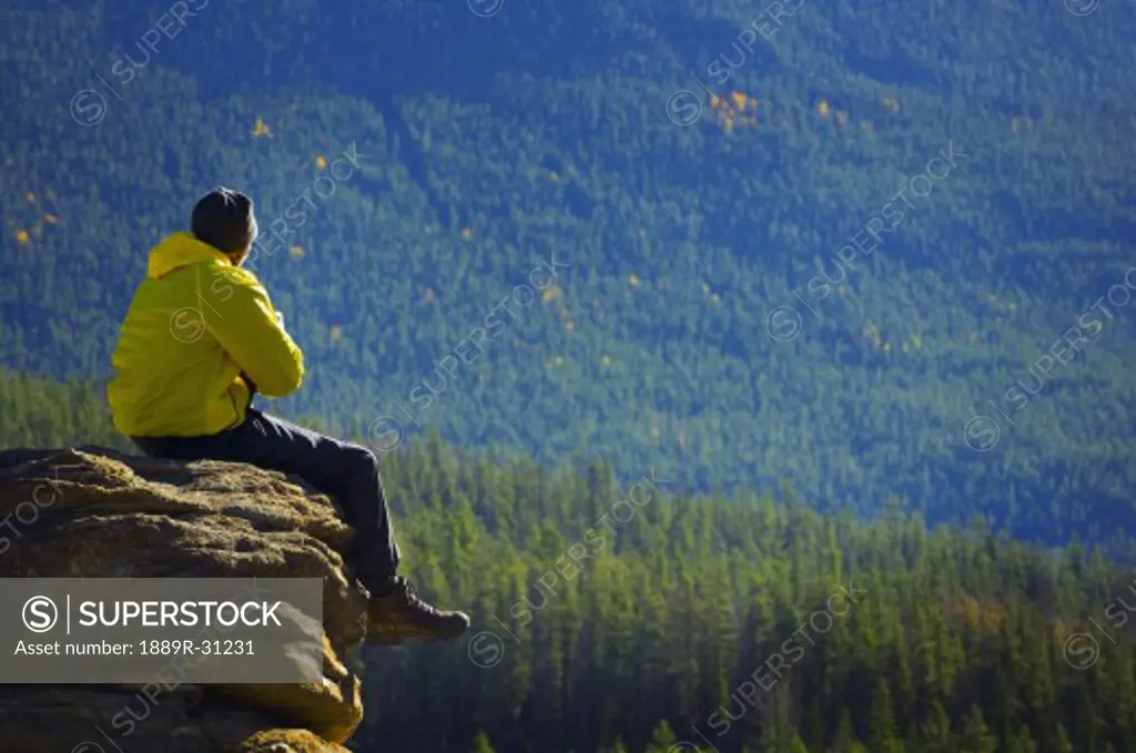 Man pondering his mountain surroundings  