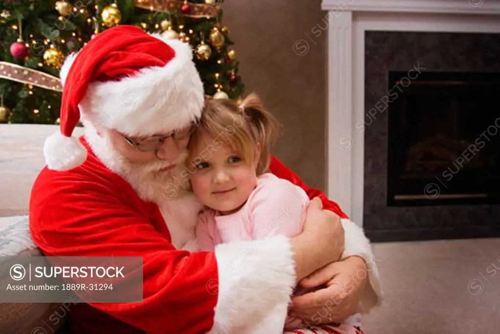 Santa Claus hugging a little girl