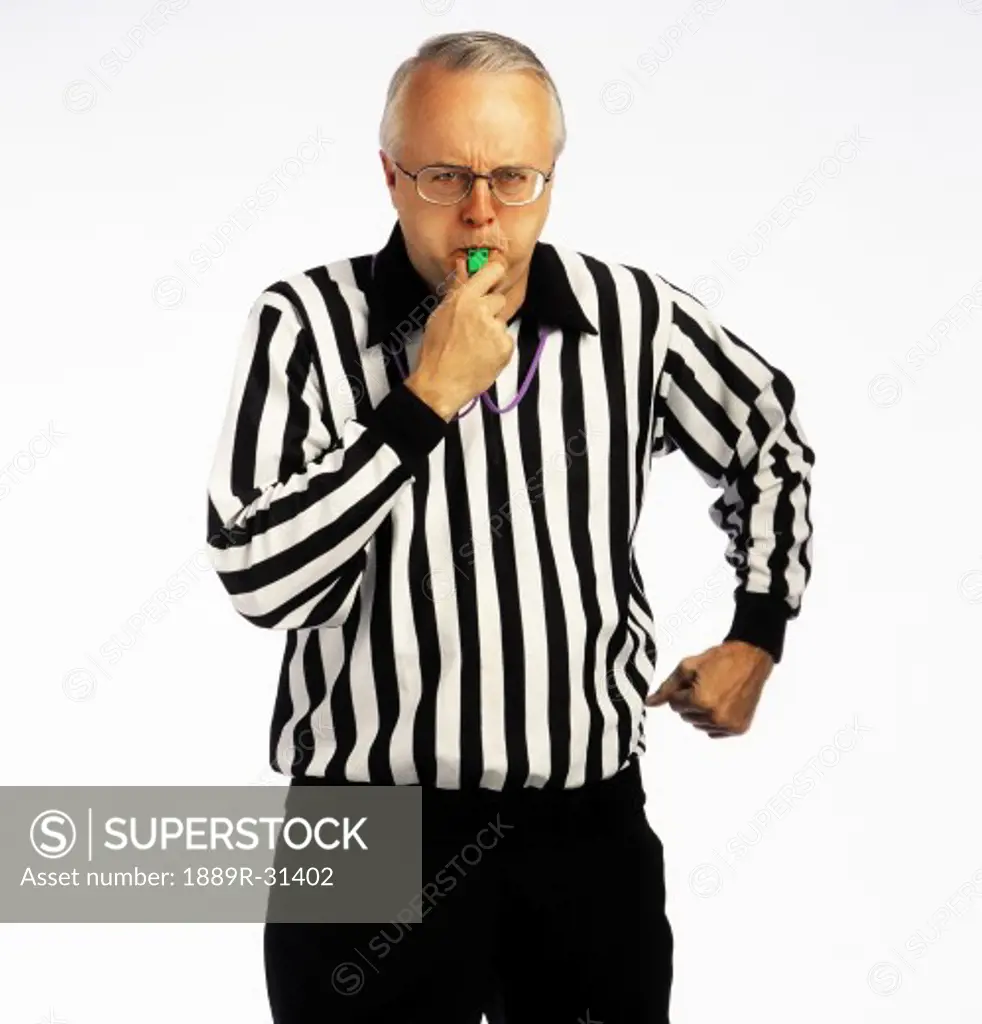 Referee blowing a whistle