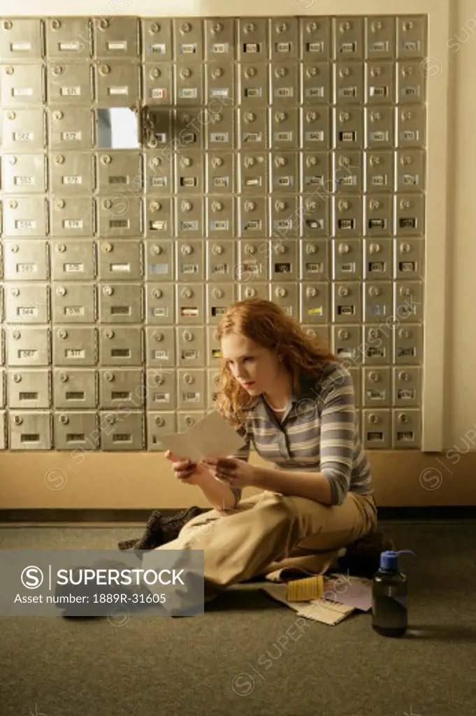 Lady opening mail at post office boxes