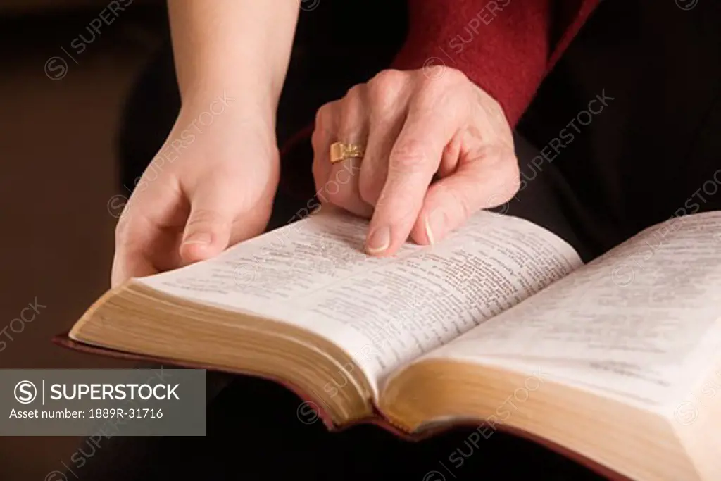 Two people reading the Bible