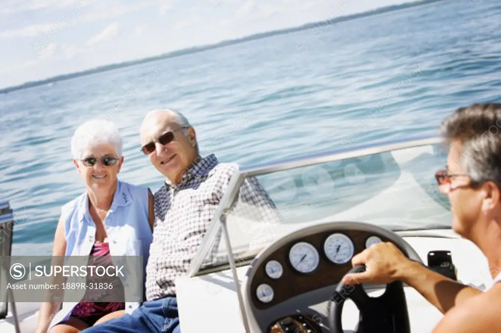 Senior couple and man in a speed boat