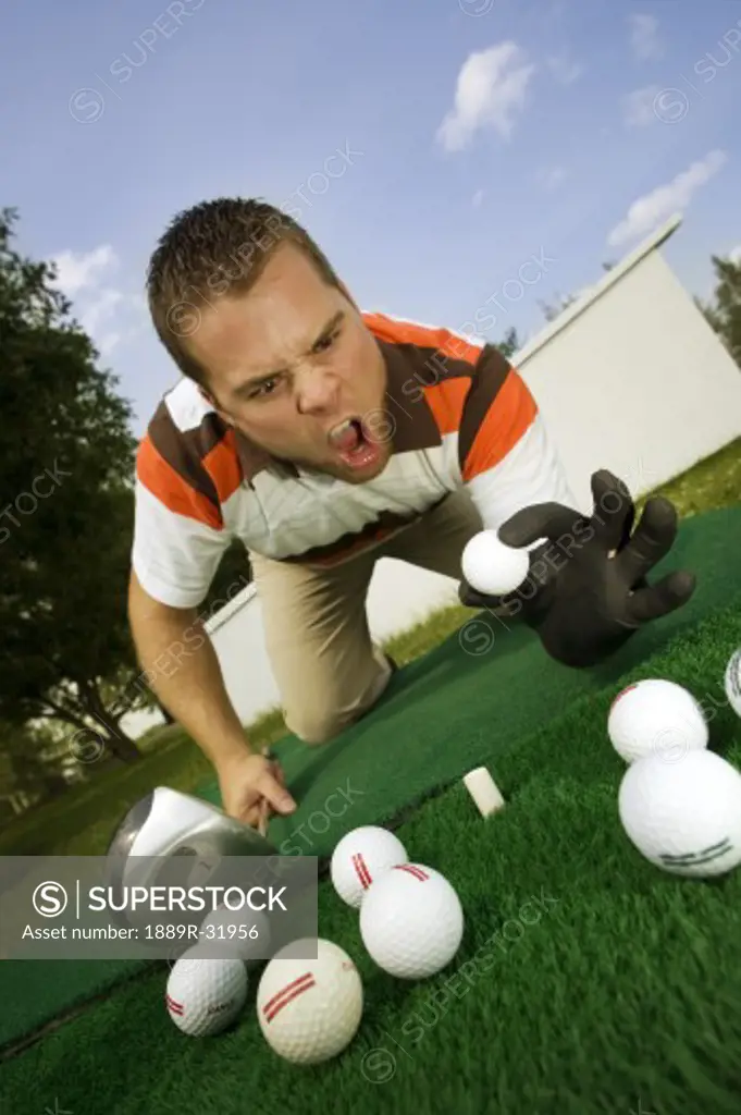 Frustrated golfer yelling at golf balls