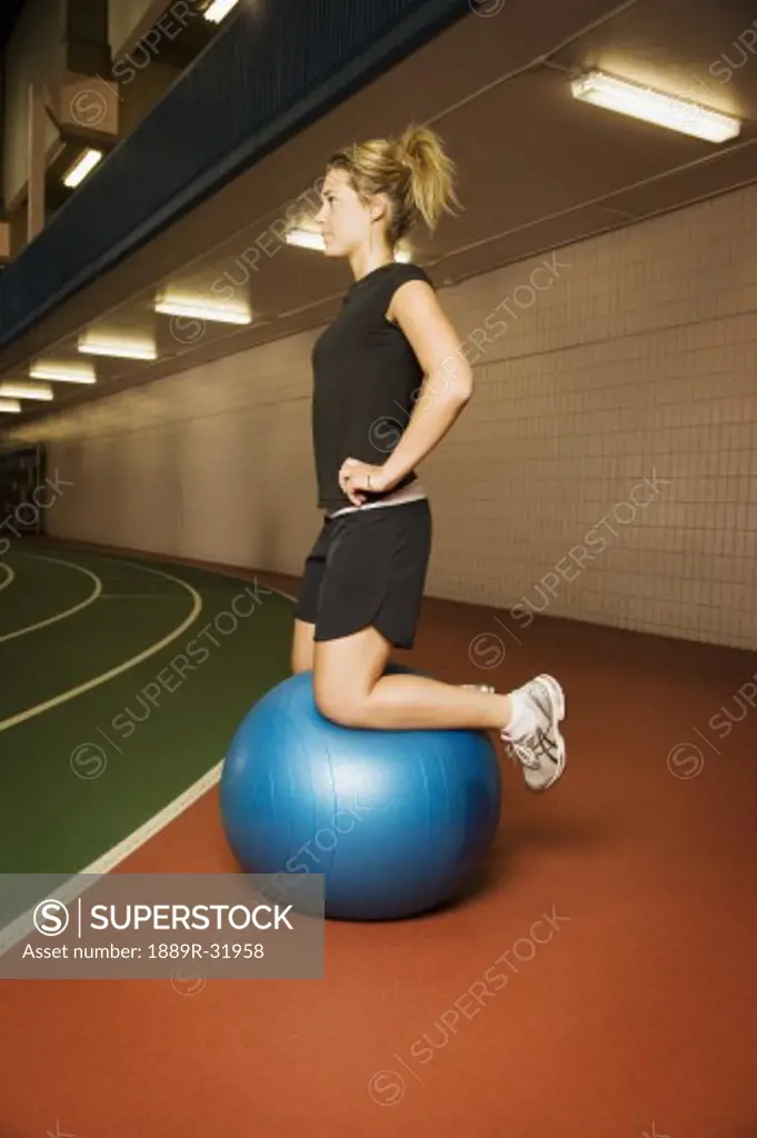 Side view of woman on exercise ball