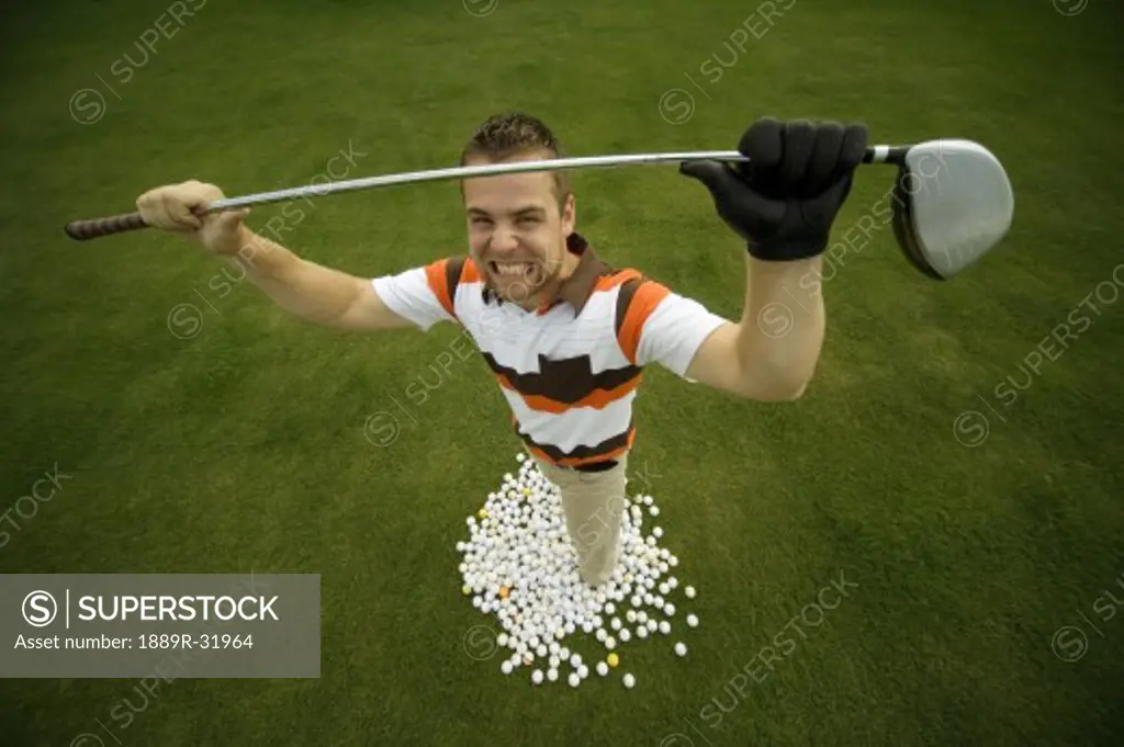 Frustrated golfer standing with balls
