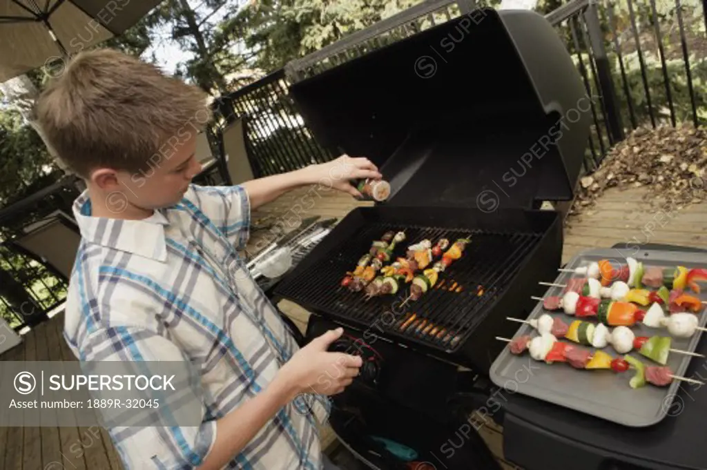 Boy barbecuing outdoors