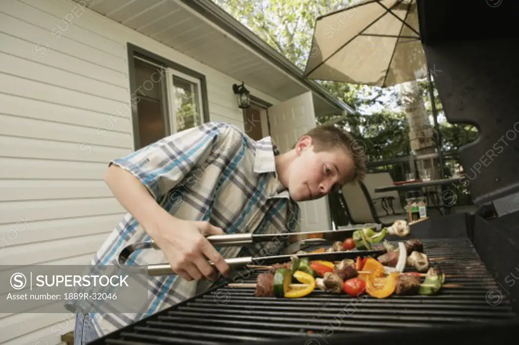 Boy barbecuing outdoors