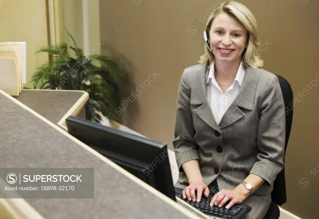 Businesswoman on computer and phone
