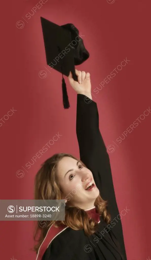 Portrait of graduate holding cap