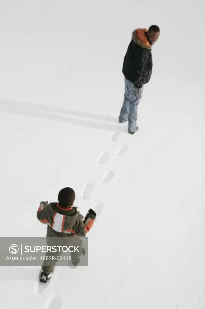 High angle view of people walking on snow