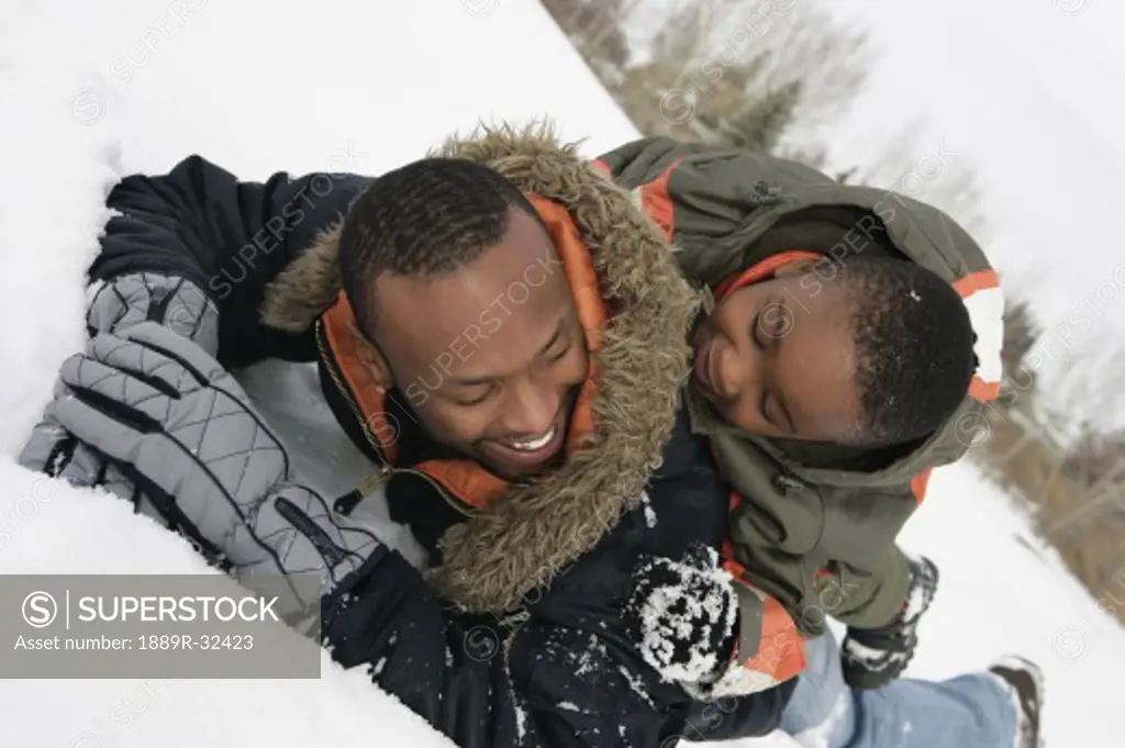 Father and son playing on snow