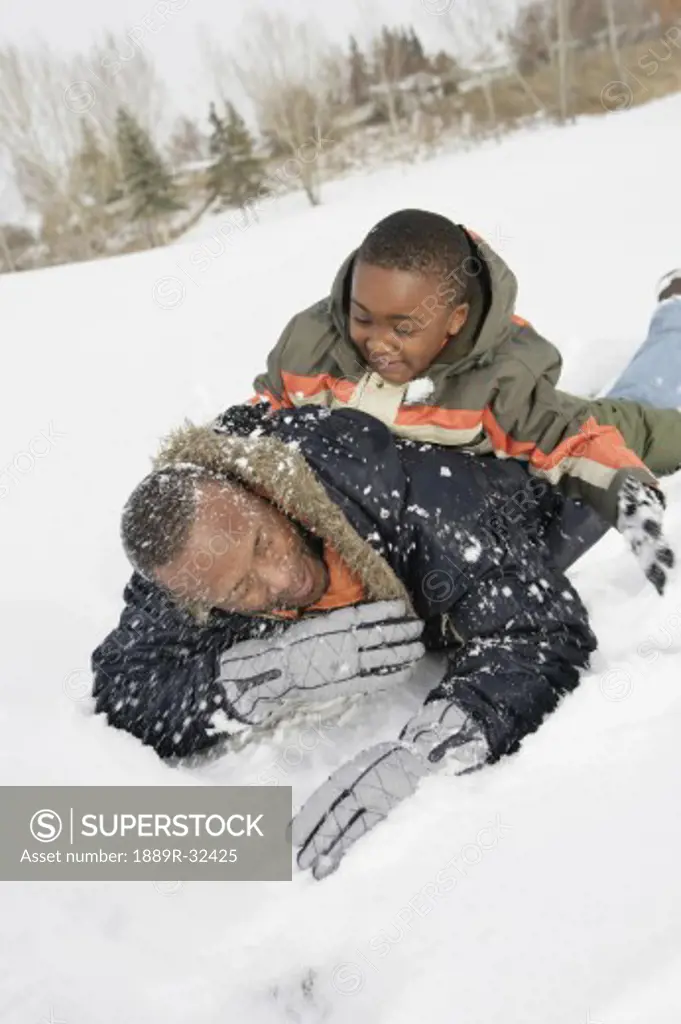 Father and son playing on snow