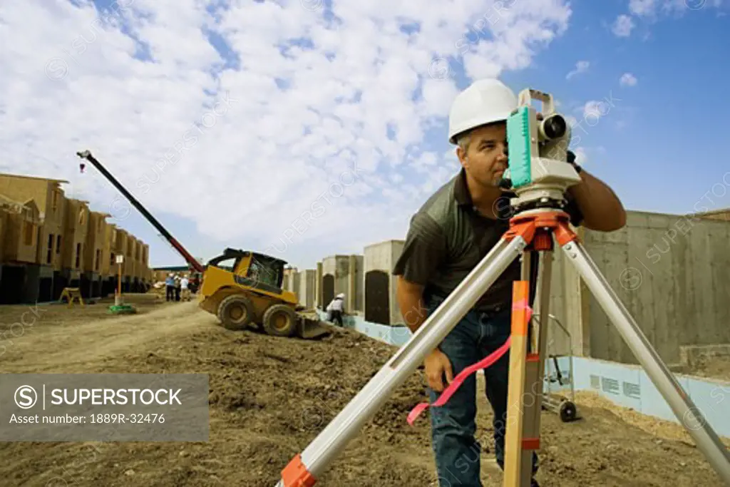 A surveyor at a construction site