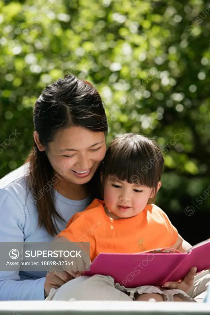Mother reading to daughter