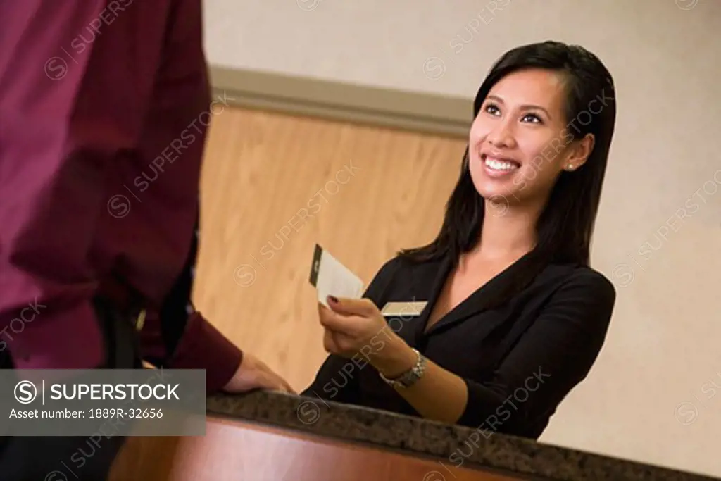 Hotel clerk giving a key to a customer