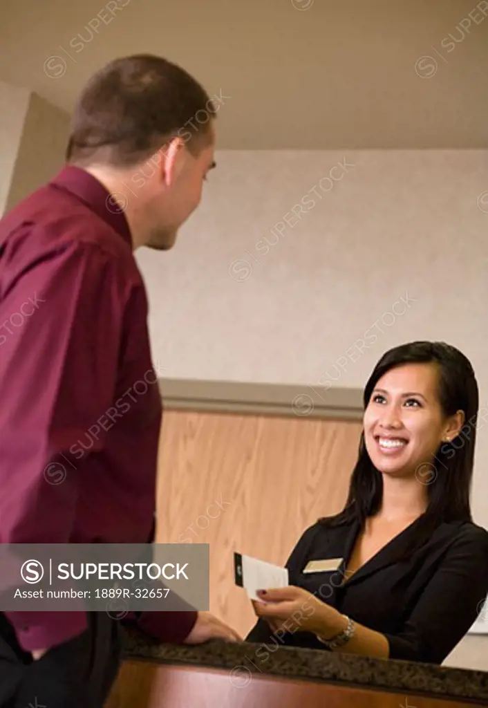 Hotel clerk giving a room key