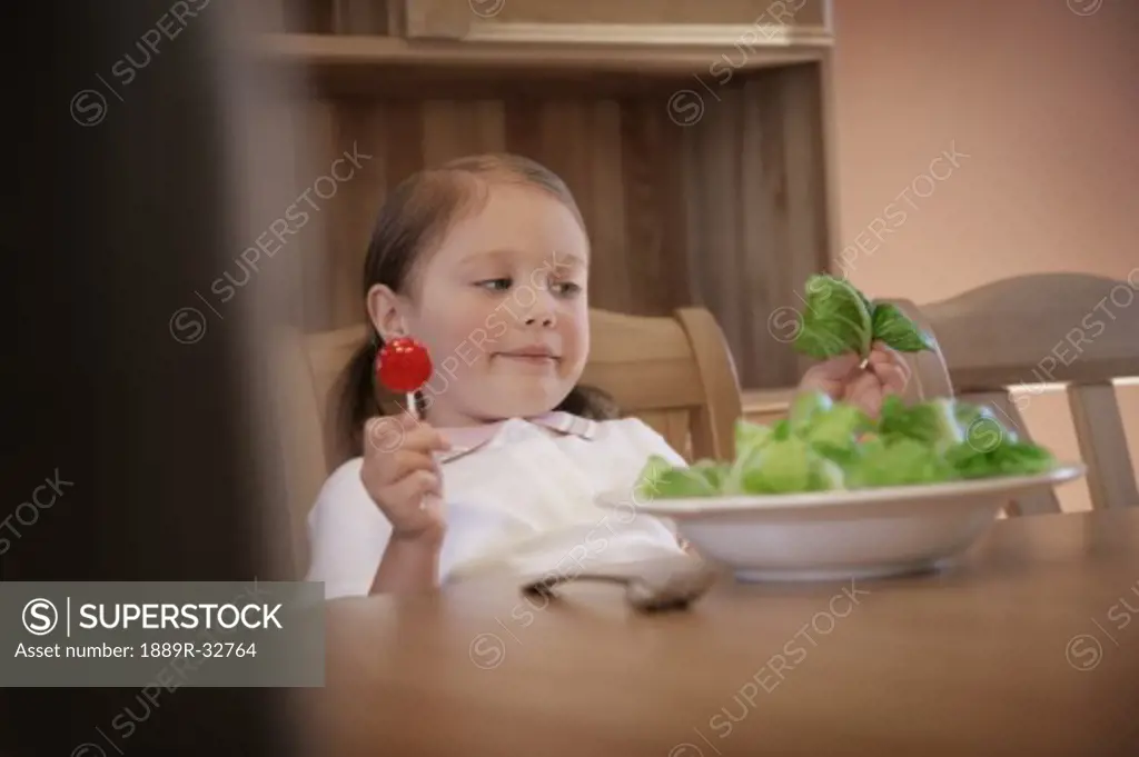Child debates which food to eat  