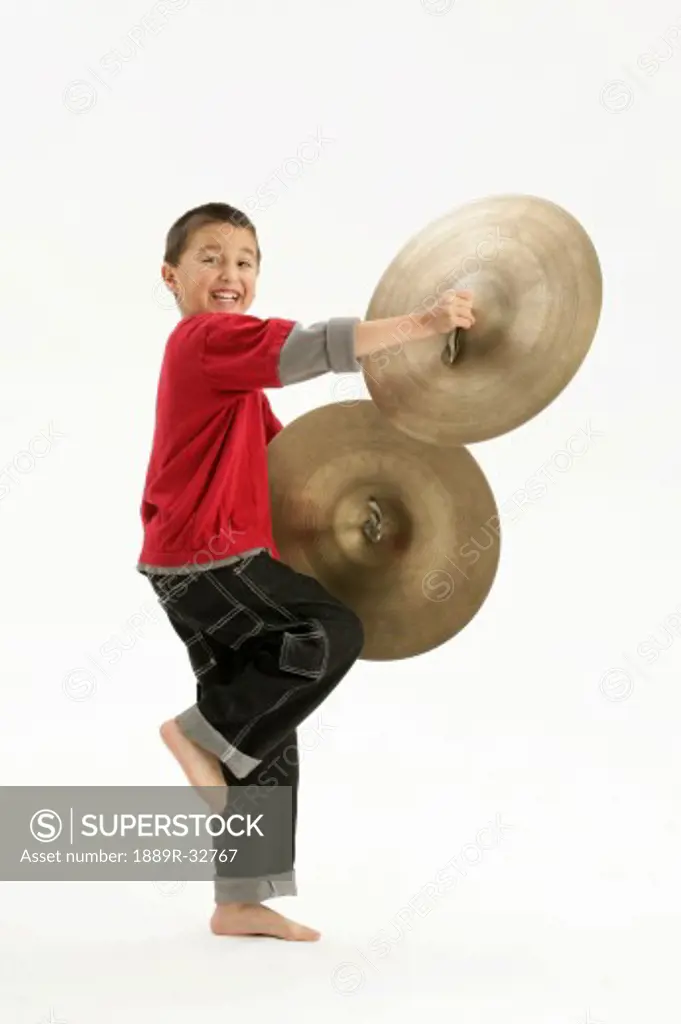 A boy holding cymbals