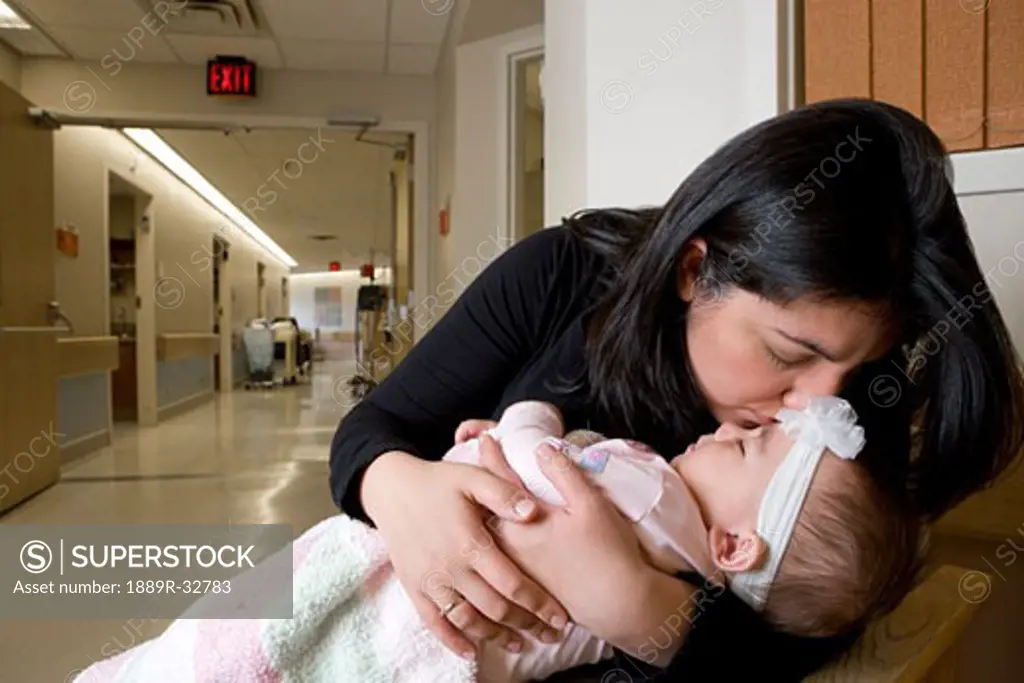 Woman kissing baby girl