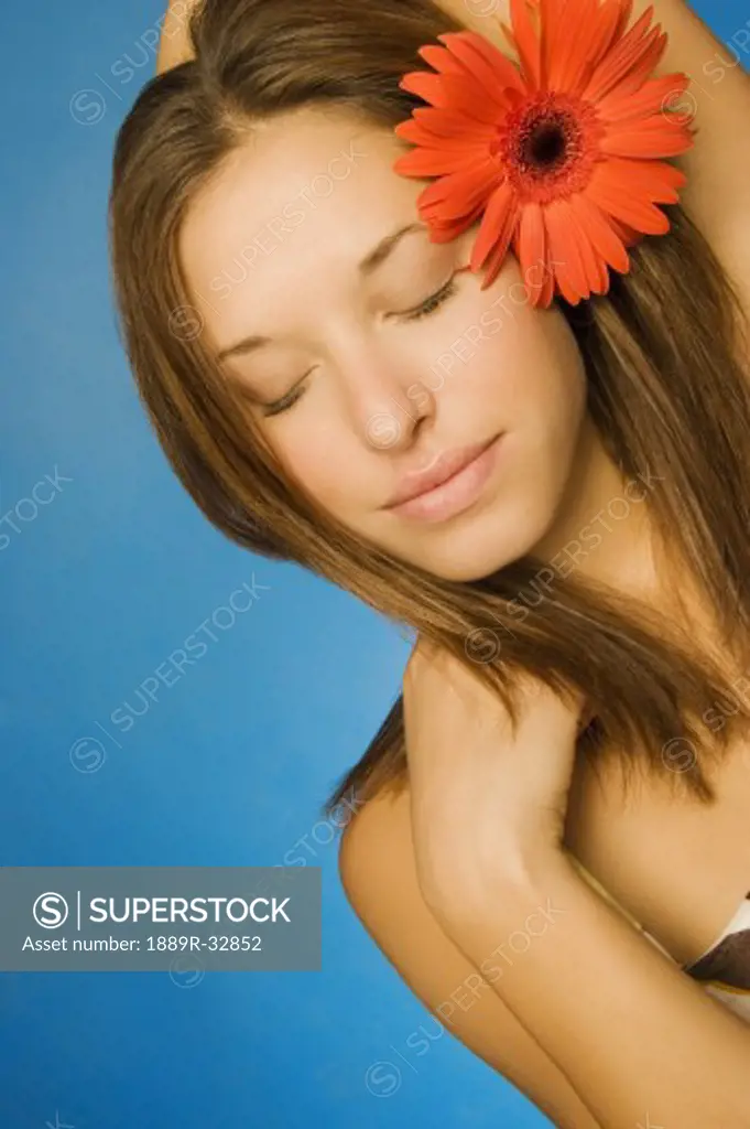 Brunette model with gerbera daisy