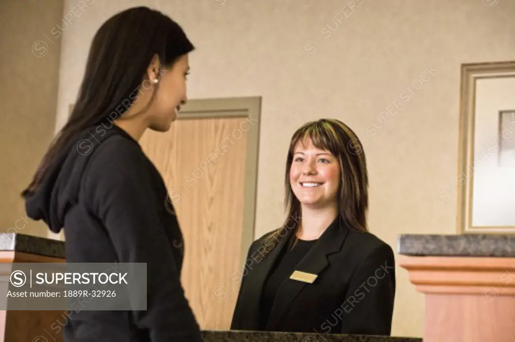 Woman checking in at hotel lobby