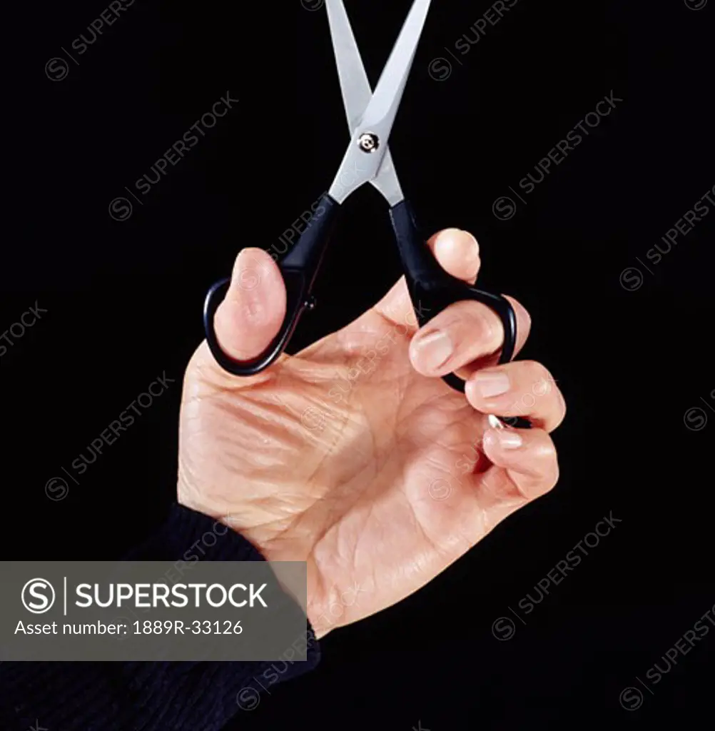 A hand holding scissors