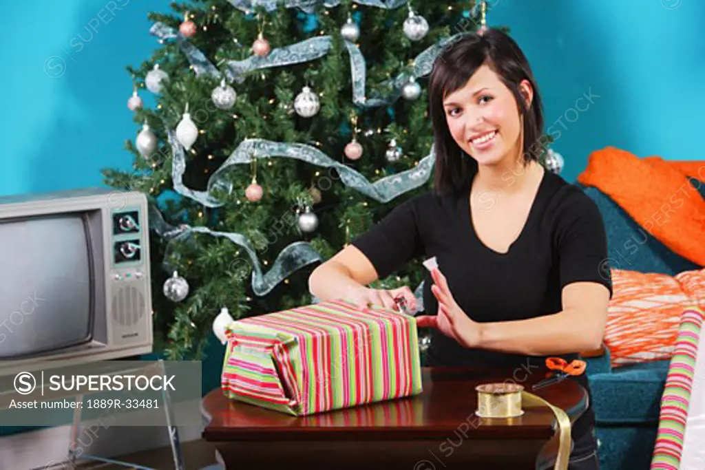 Woman wrapping a gift