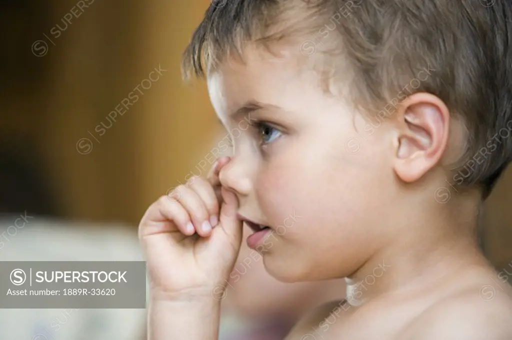 Little boy picking nose  