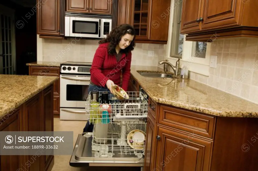 Woman filling dishwasher