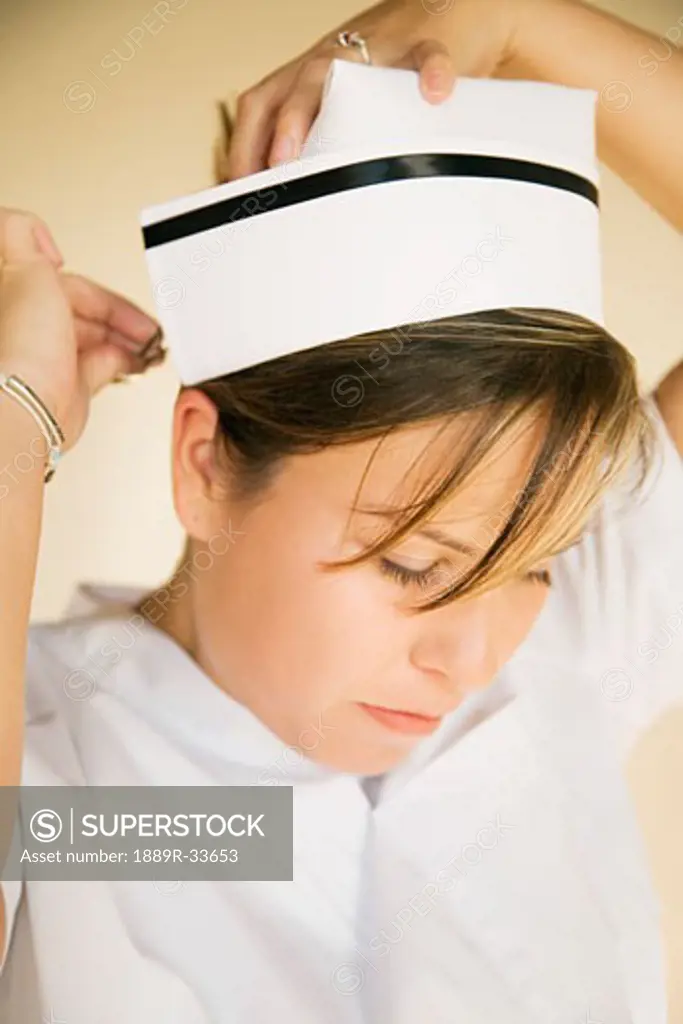 Nurse pinning on cap