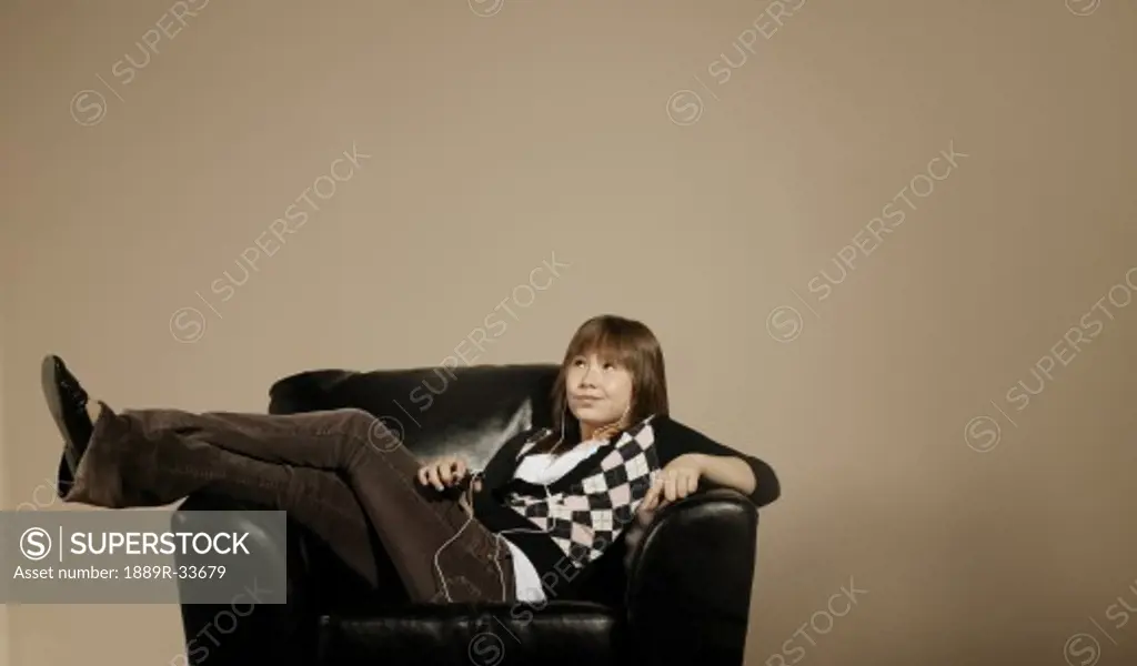 Girl listening to music in chair