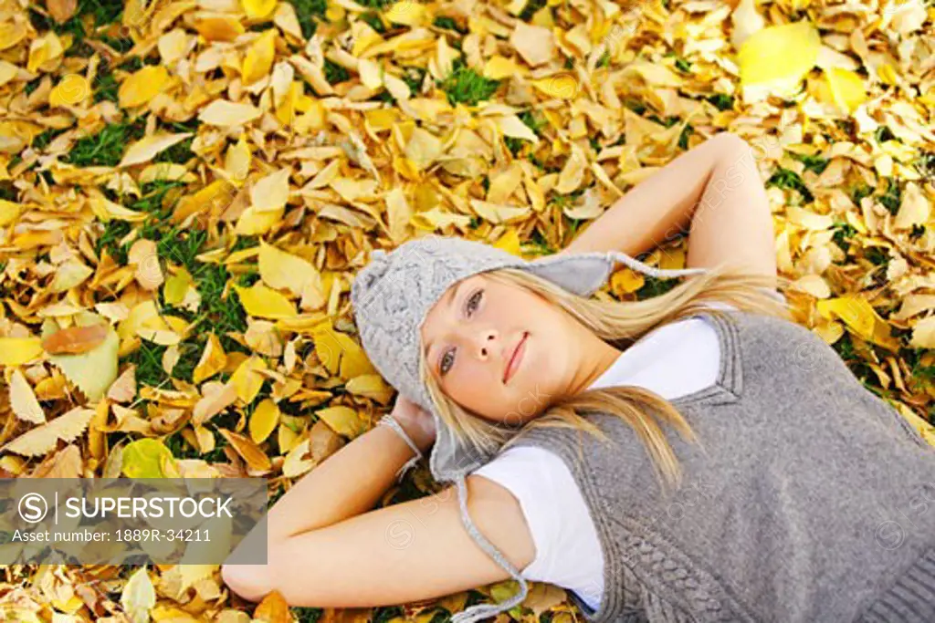 Young girl laying in the leaves