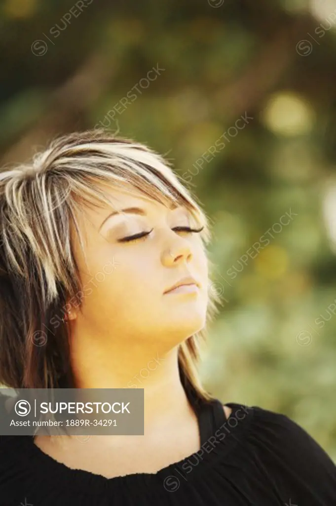 Woman looking relaxed with eyes closed