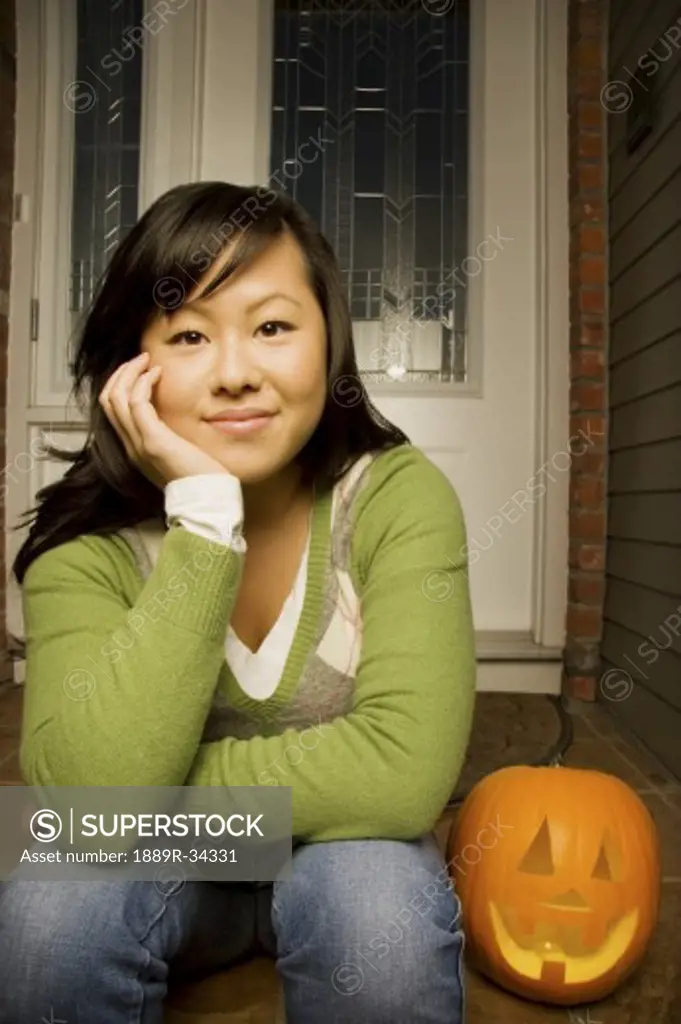 Young girl with carved pumpkin