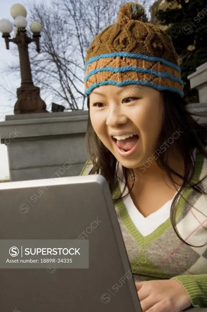 Girl excited about what she sees on computer