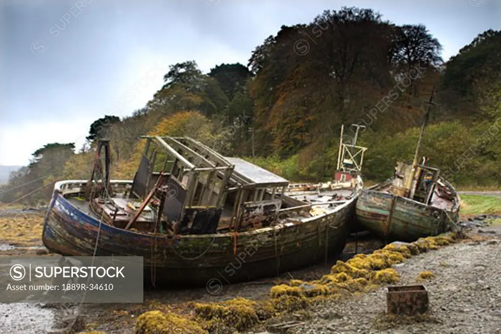 Two old and abandoned boats on the shore of Isle of Mull, Scotland