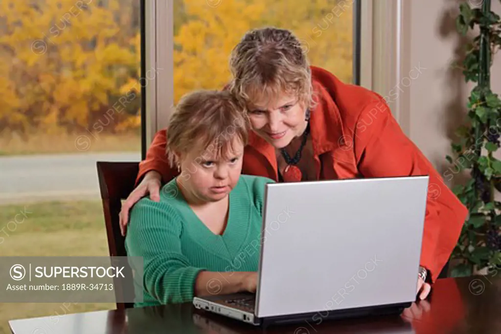 Mother and daughter with lap top computer