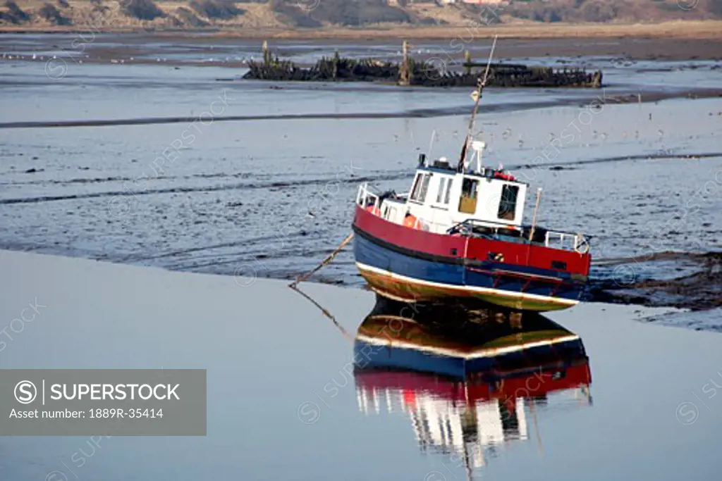 A boat moored by shore, Amble, Northumberland, England