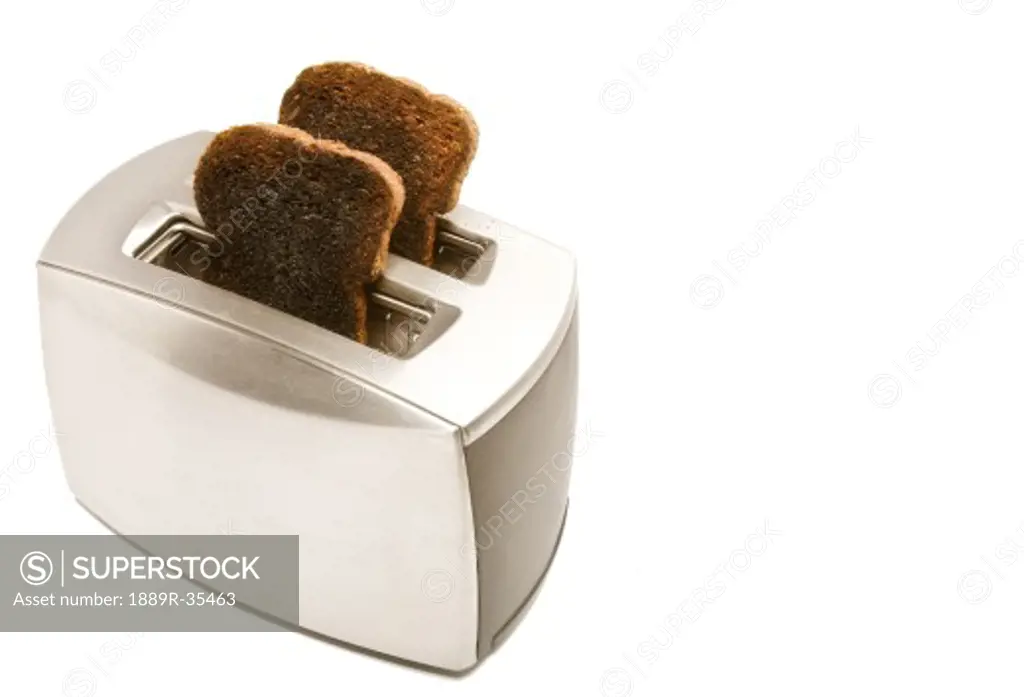 Burnt toast popping out of a toaster