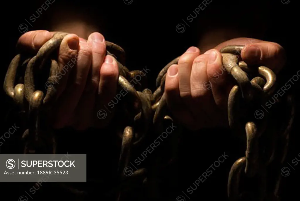 Hands holding chains