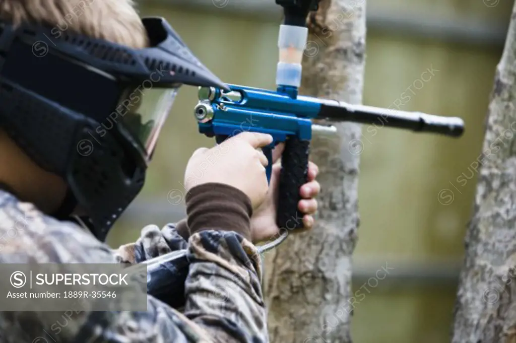 Person aiming paintball gun
