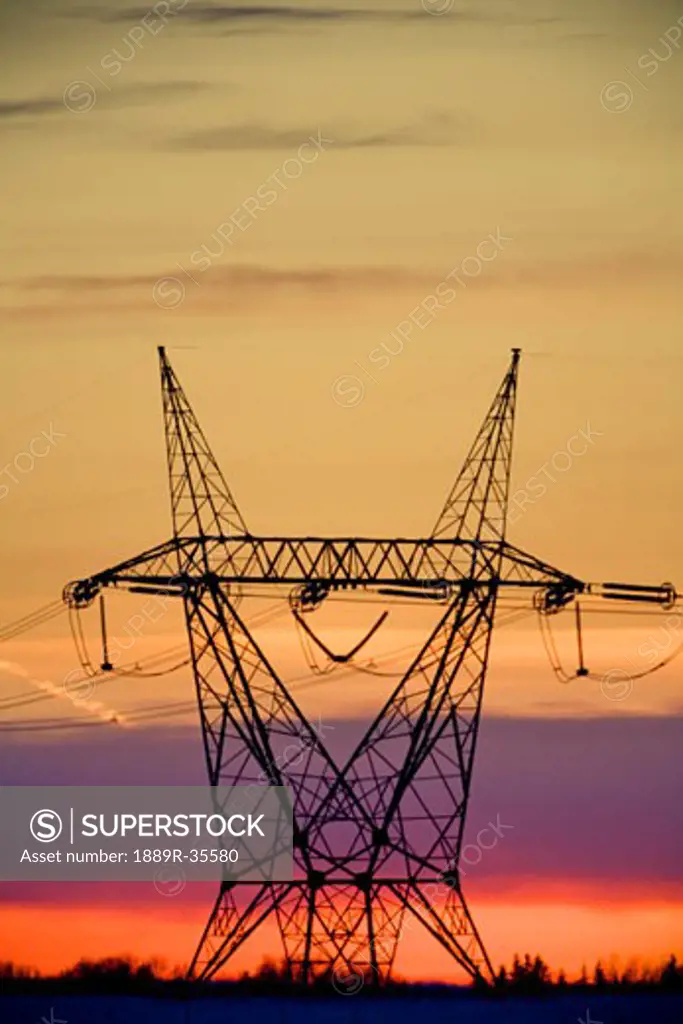Silhouetted transmission tower