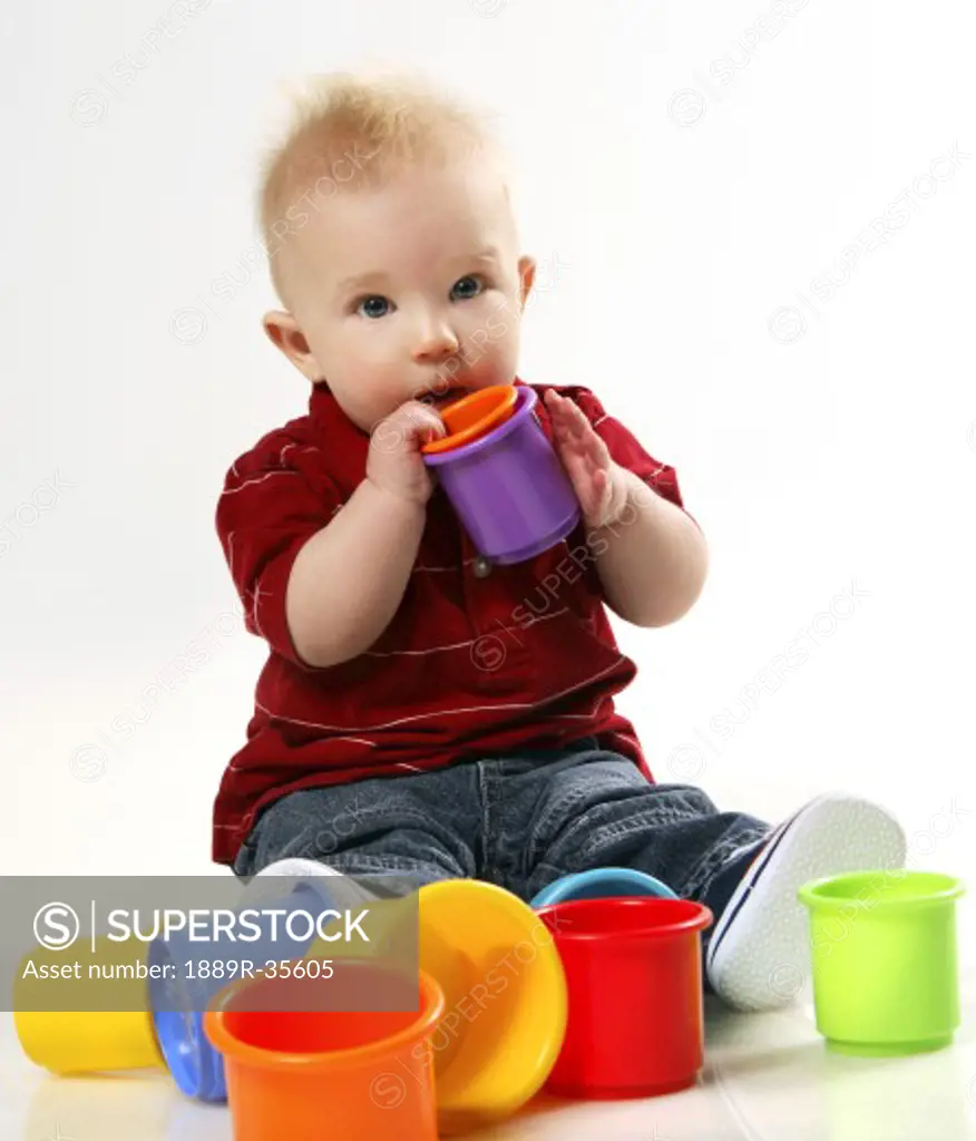 Baby boy playing with stacking cups