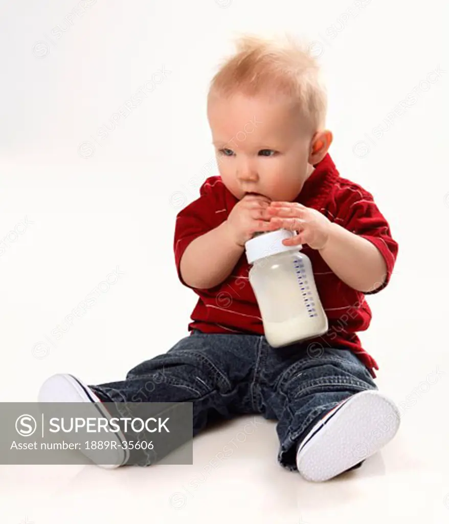 Baby boy with a bottle of milk